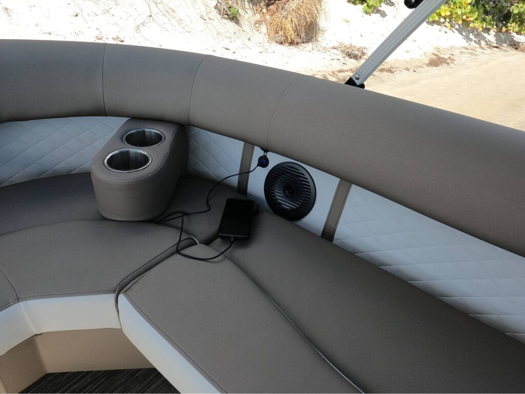 cell phone charging on seat of pontoon
