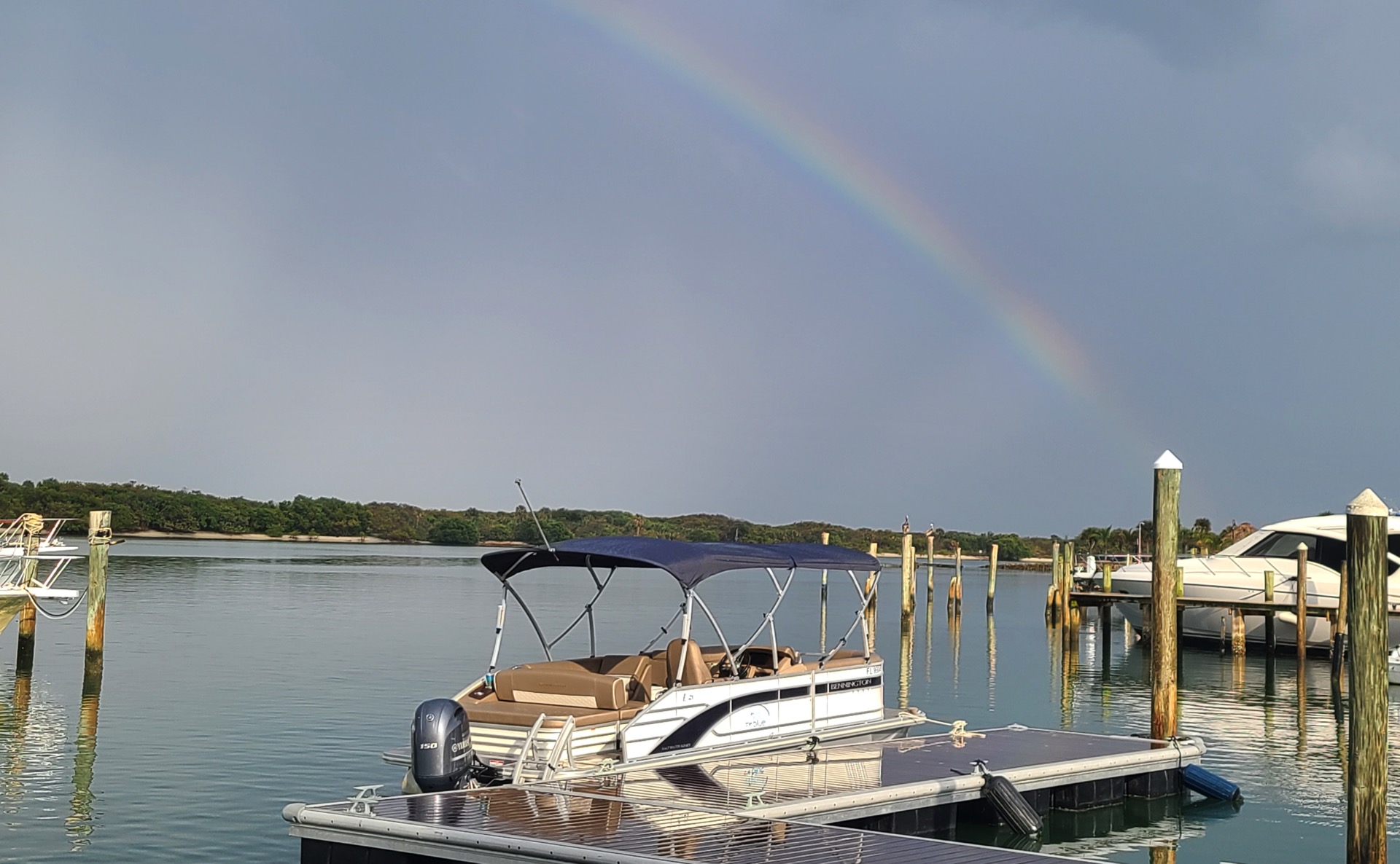 Our pontoon boat with a rainbow overhead