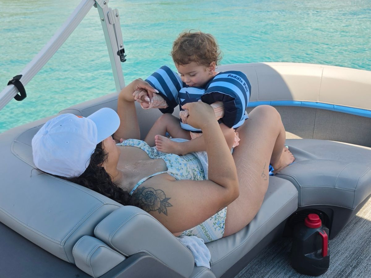 Guest relaxing with a child aboard Blue Bliss Charters at Peanut Island